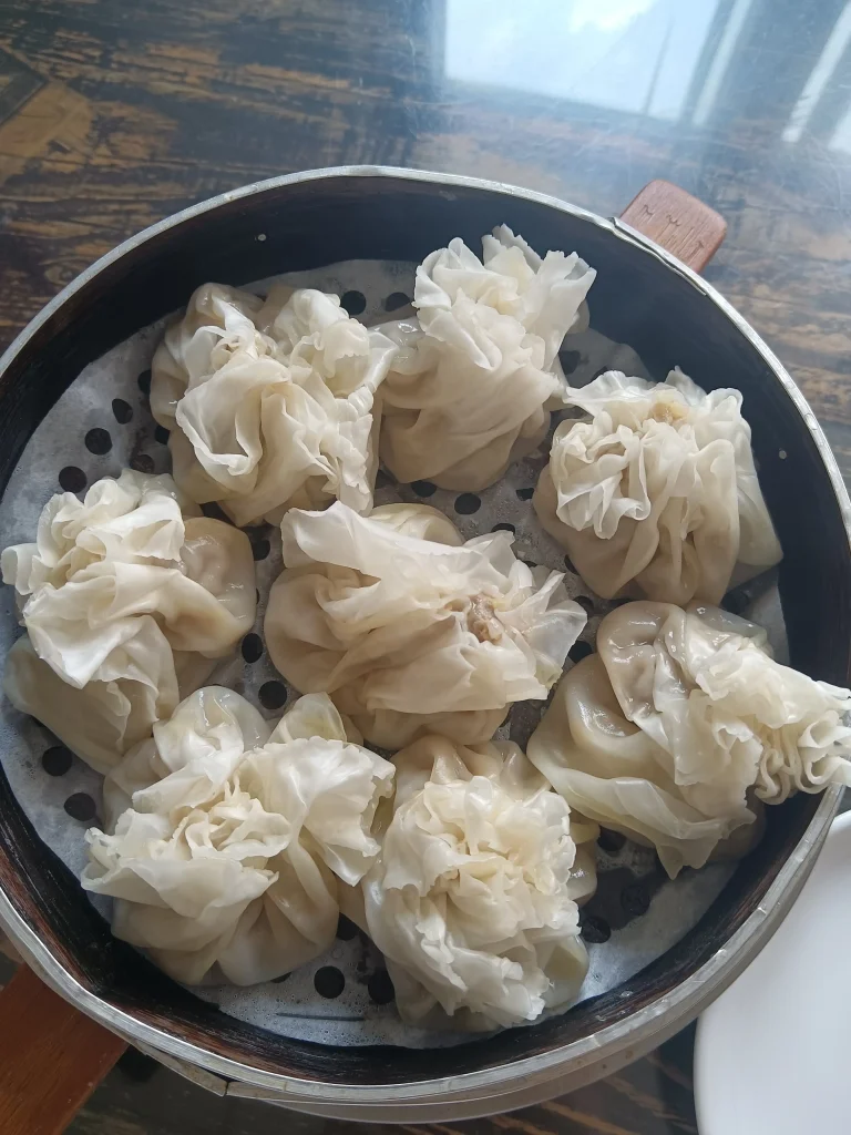 Steaming basket of traditional Hohhot shaomai dumplings at breakfast